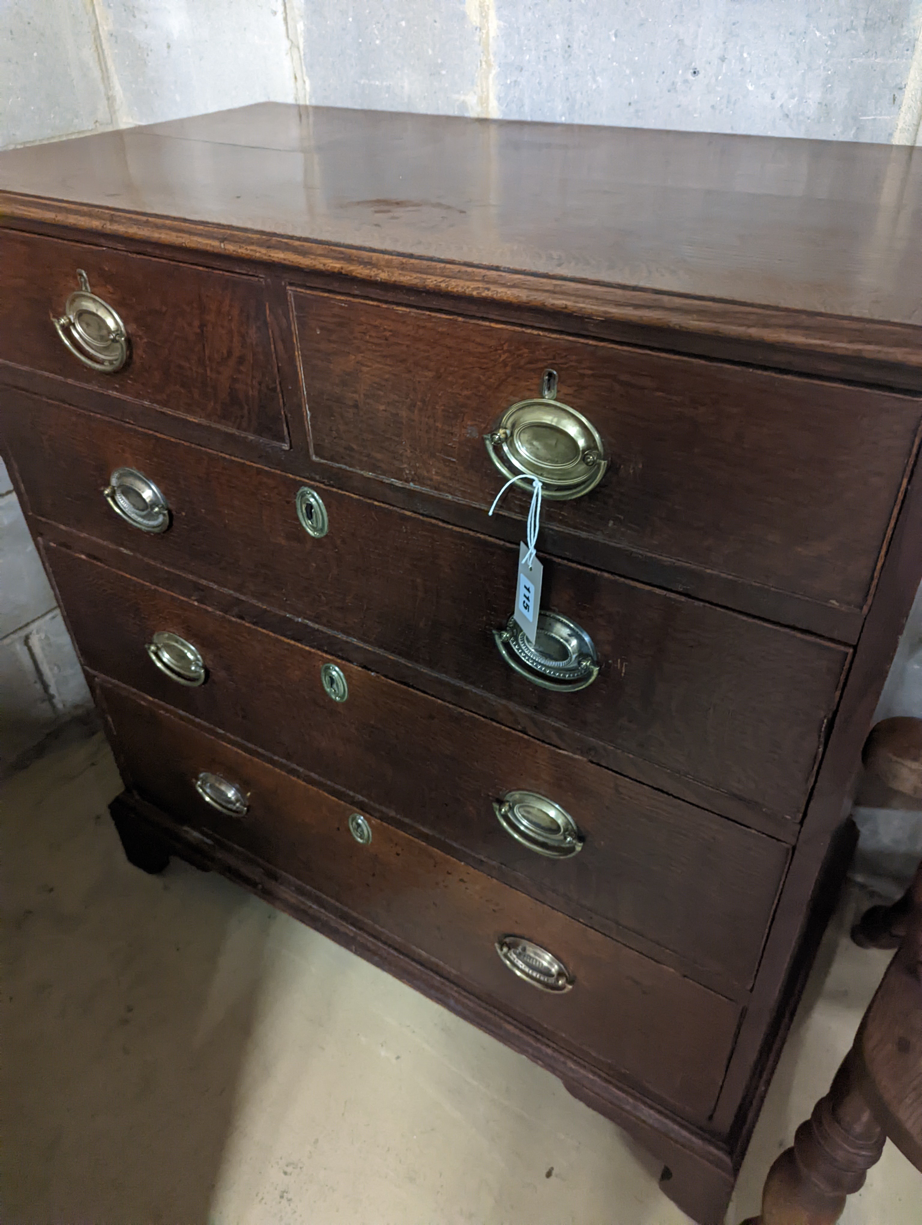 A George III oak chest of two short and three long graduated drawers, . W-94cm, D-51cm, H-99cm.